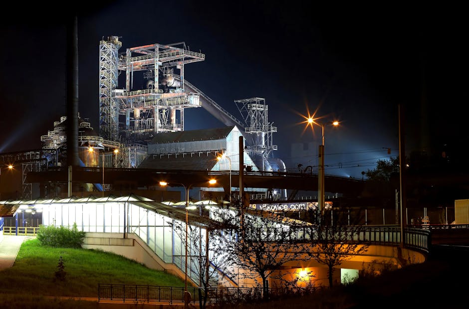 A beautifully illuminated industrial plant with steel structures shining against the night sky.